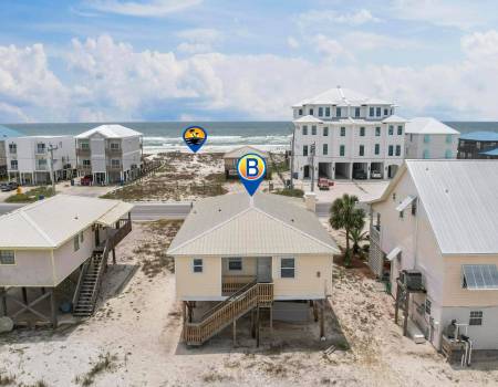 Beach house with the ocean in front of it