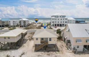 Beach house with the ocean in front of it